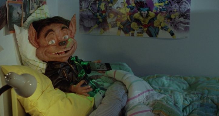 Munchie in bed. A pretty sweet xmen poster behind him.