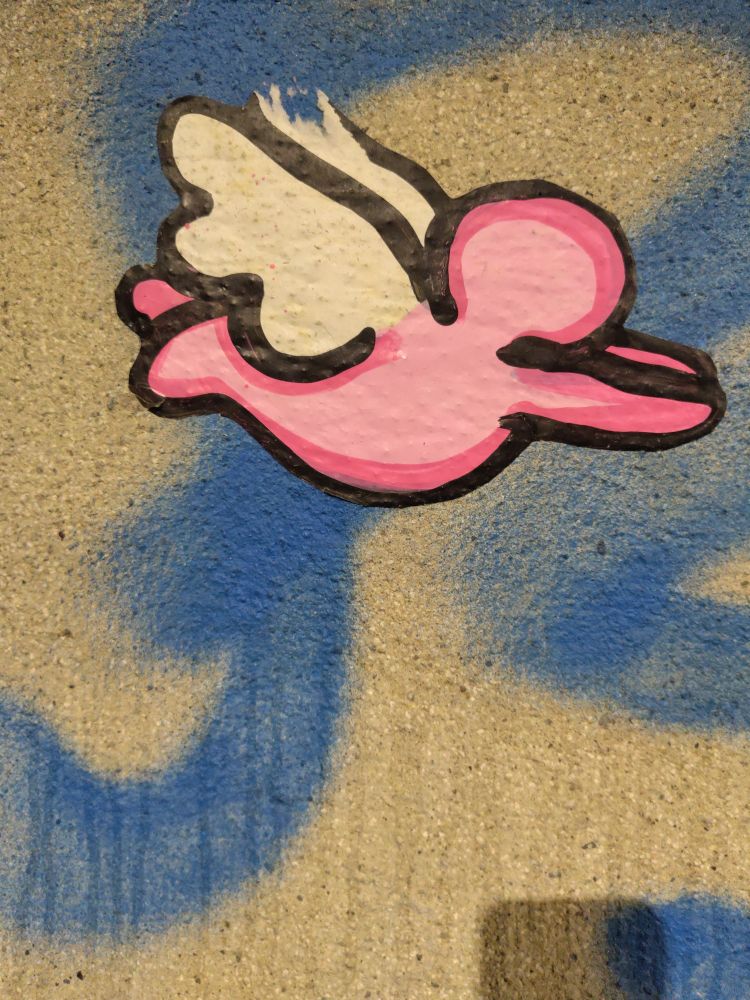 a flying pink body with wings on the background a wall blue and cream. You can think of an angel of hope if help your 💜