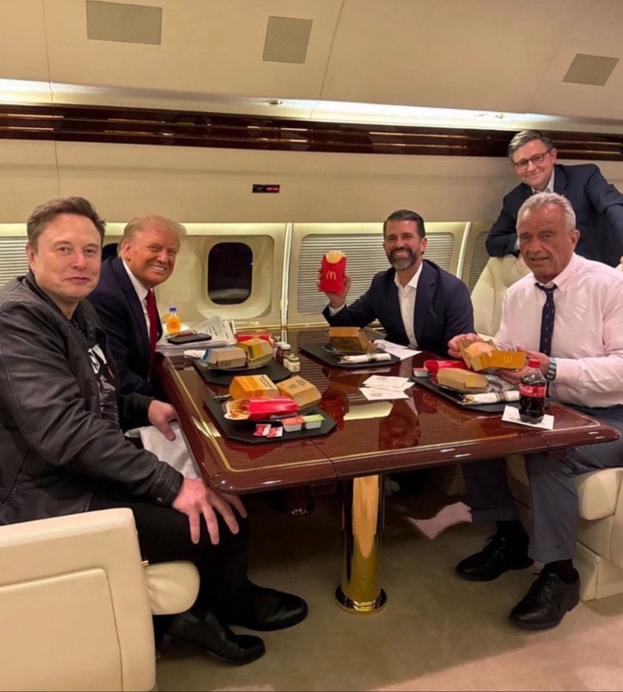 Trump and some of his cabinet picks seated at a dining table inside a private jet smiling for camera while showing us they eat McDonald's fast food.
Left side of table: Elon Musk, Donald Trump. Right side of table: RFK Jr, JD Vance, and some other a-hole standing behind him whose name I probably ought to know, but don't and I don't feel like looking up.