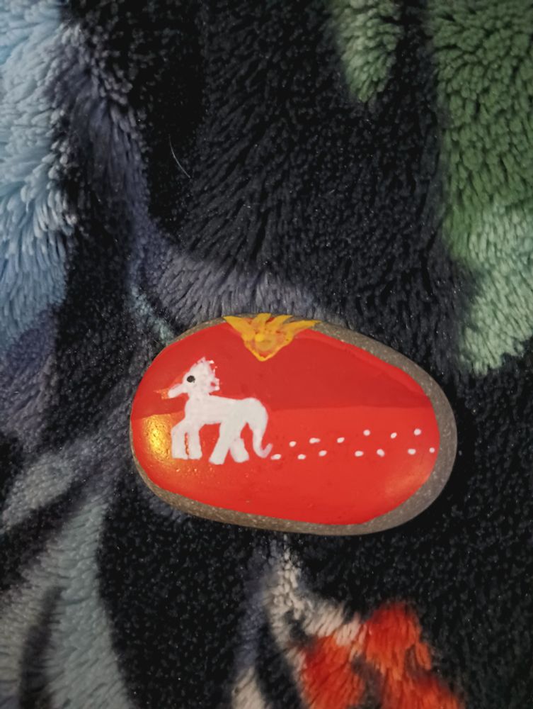 White ash horse on red terrain painted on rock