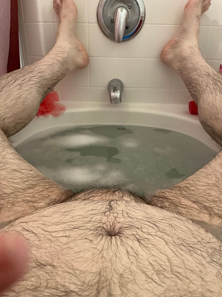 Naked hairy chubby guy in sudsy bathtub