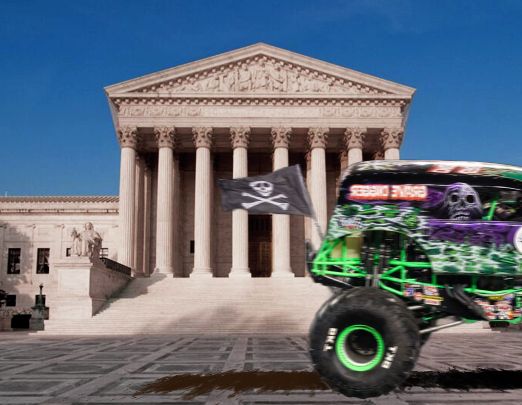 grave digger driving in front of the supreme court building, there's a big brown splat underneath its tires, yucky! looks like poo poo