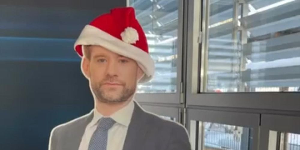 a cut out of a man wearing a santa hat