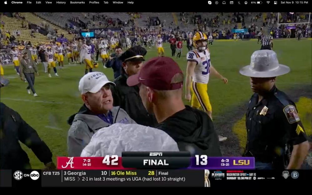 Screen shot of the Alabama and LSU coaches shaking hands at the end of the football game Saturday night. State police are escorting the coaches while the LSU team walks off the field. In the background you can see a nearly empty Death Valley Stadium, seconds after the game ended.
The final score Alabama 42 - LSU 13 is displayed on a banner at the bottom of the screen.
This was particularly delicious for us, as we are decidedly not LSU fans, and we have been very mad at the school for the decision to bring an actual tiger in a cage to the stadium to be on the sidelines during the game. And not even Mike VII, who was comfortable in his enclosure on LSU's campus. This was a different tiger the school officials decided to torture. Leave wild animals alone and out of stadia.