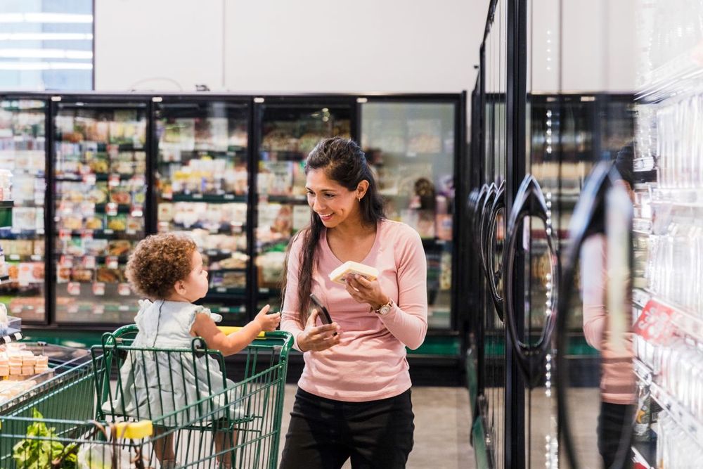 Happy mother and child shopping for groceries at supermarket
