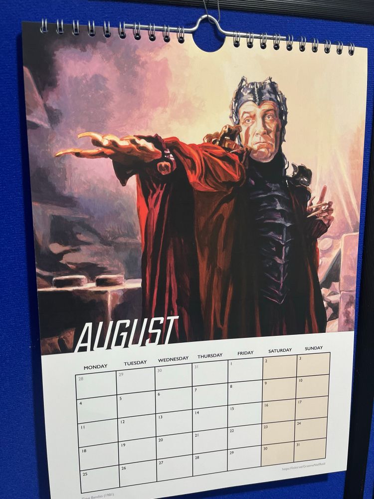 Photograph of a calendar showing the month of August and featuring a painting of the character Evil from the film Time Bandits.