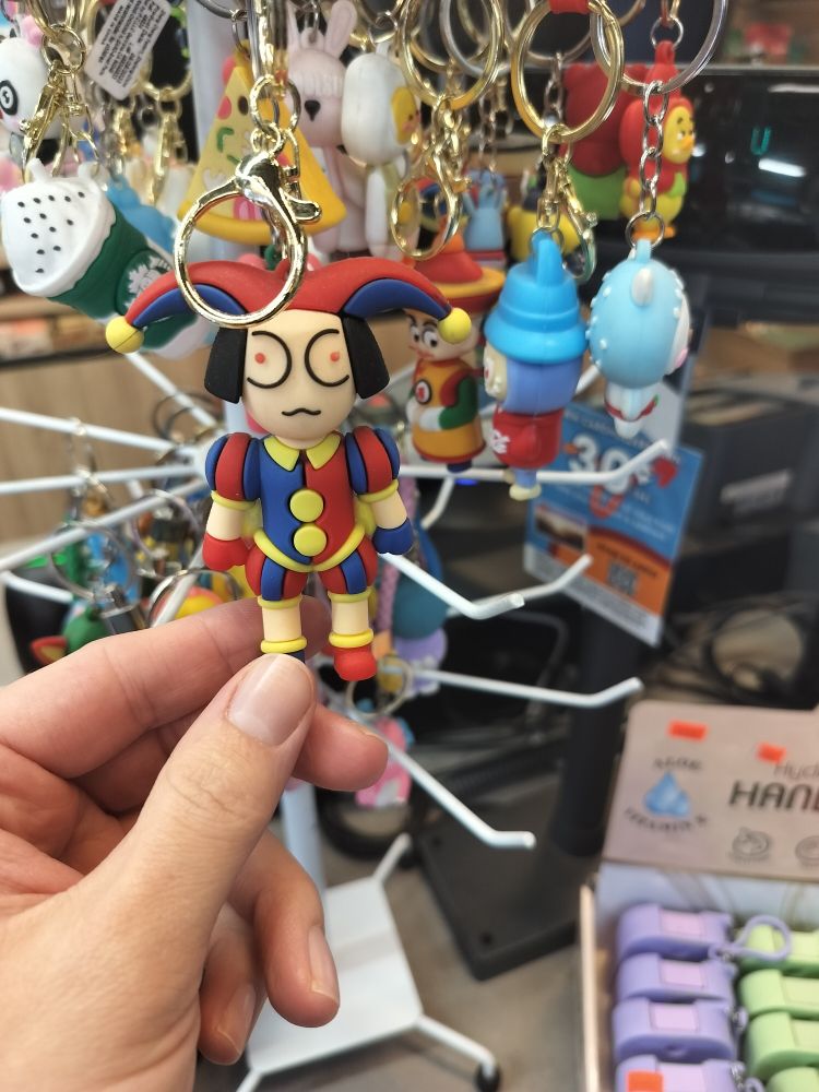 a vaguely pomni shaped plastic jester keychain