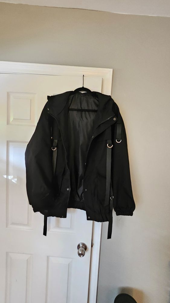 Black jacket hanging from the door
