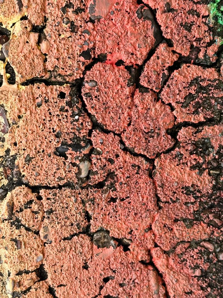 Orange paint on cracked cement