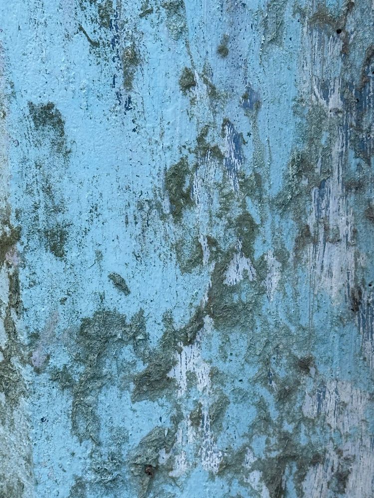 Scratched blue paint on concrete