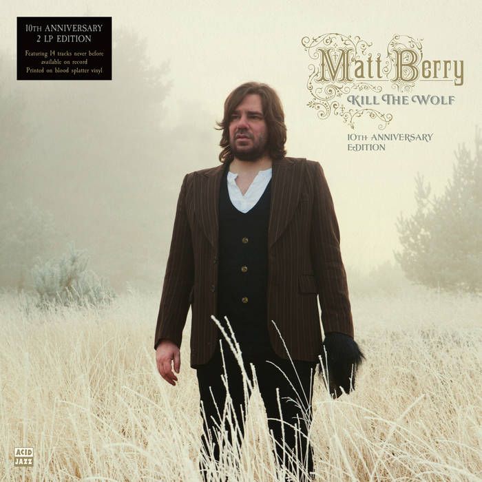 Matt Berry's album Kill the Wolf, 10th Anniversary Edition features the artist in a suit, with one furry hand standing in a field of very light-colored grasses against a foggy background.