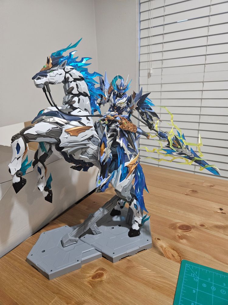an image of a white and blue model kit depicting a mech stylized in wuxia fashion riding a horse