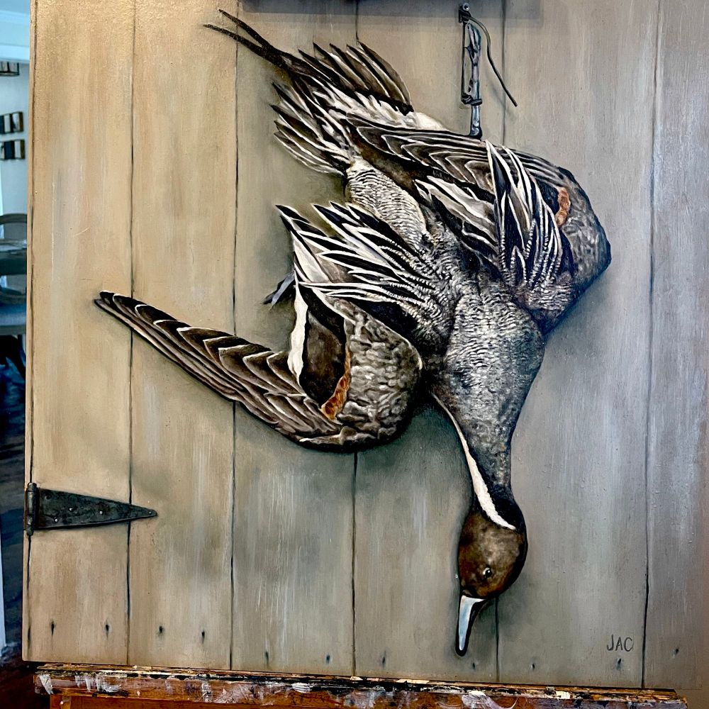 A traditional oil painting of a Pintail Duck hanging upside down