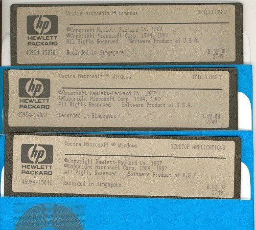 Three vintage Hewlett-Packard (HP) 5.25-inch floppy disks labeled 'Vectra Microsoft Windows,' including 'Utilities 2,' 'Utilities 1,' and 'Desktop Applications.' The disks, recorded in Singapore in 1987, feature copyright notices from HP and Microsoft.