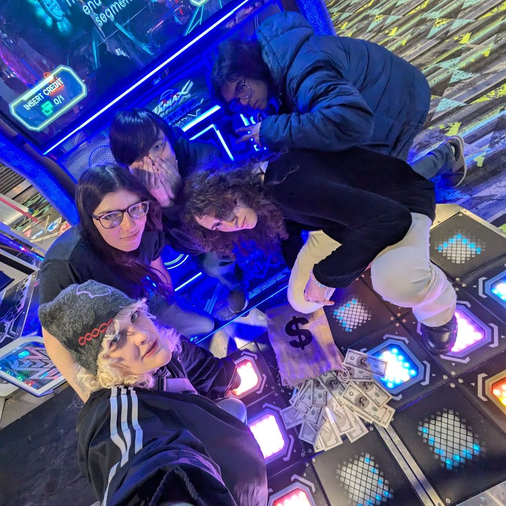 cnri, bio, dillowdrowned, a.pathrose, and julia posed on the step mania dancefloor with a money sack of wallsocket bucks spilled between them