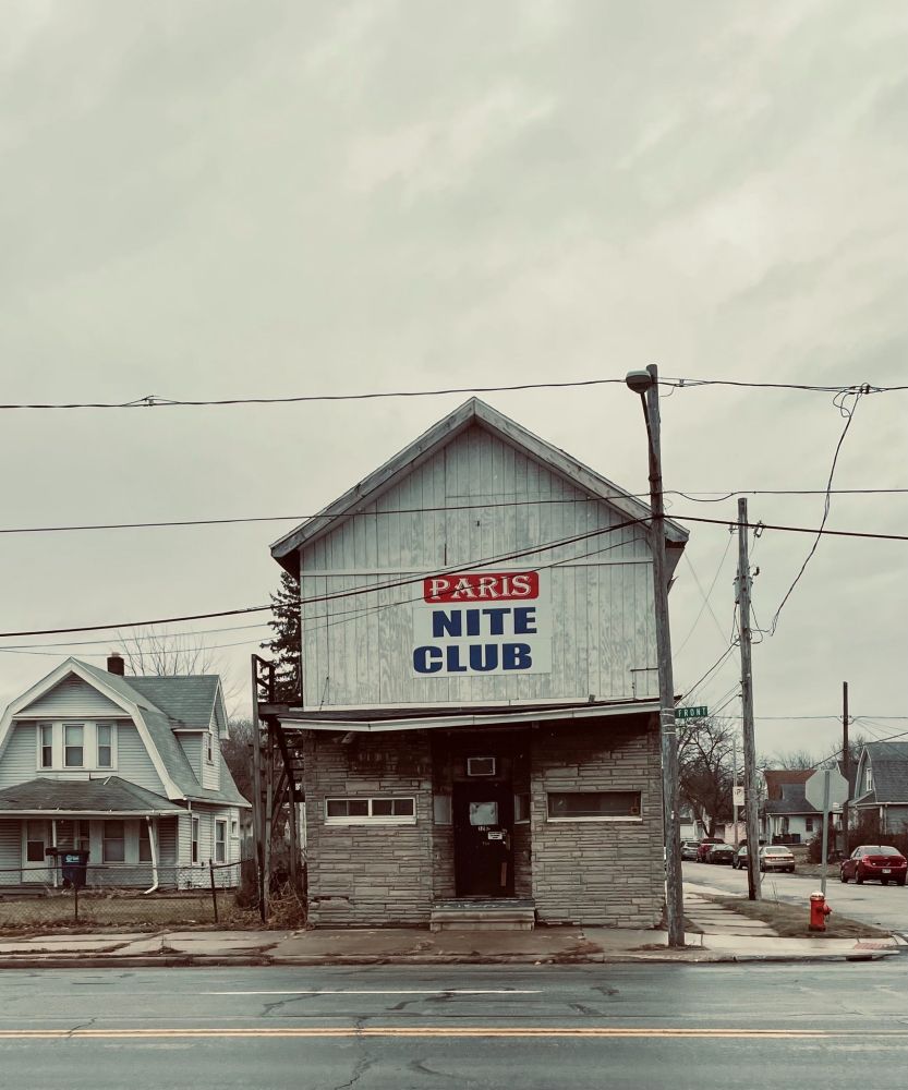 Dive bar shaped like a house called PARIS NITE CLUB.
