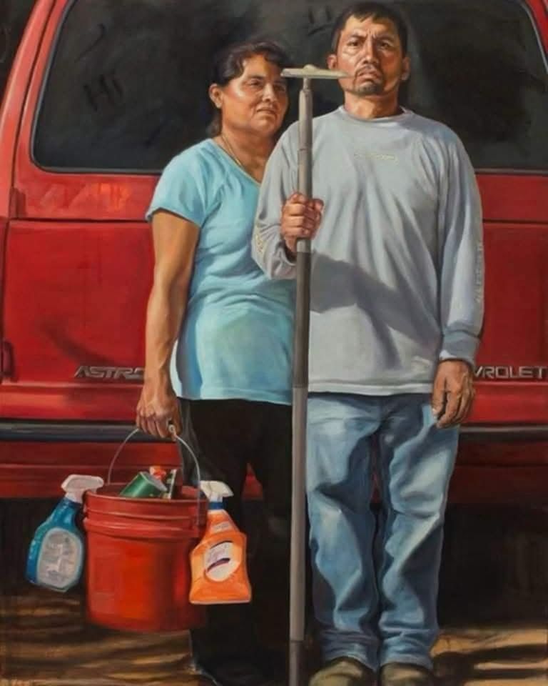 A Latina woman holding a bucket with cleaning supplies standing close behind a man who is wearing work, boots, blue jeans, and long sleeve shirt holding a hoe. Standing in front of a Chevrolet Aerostar. This painting was created to resemble the painting, American Gothic. It is a statement about America. It is the modern American Gothic.
