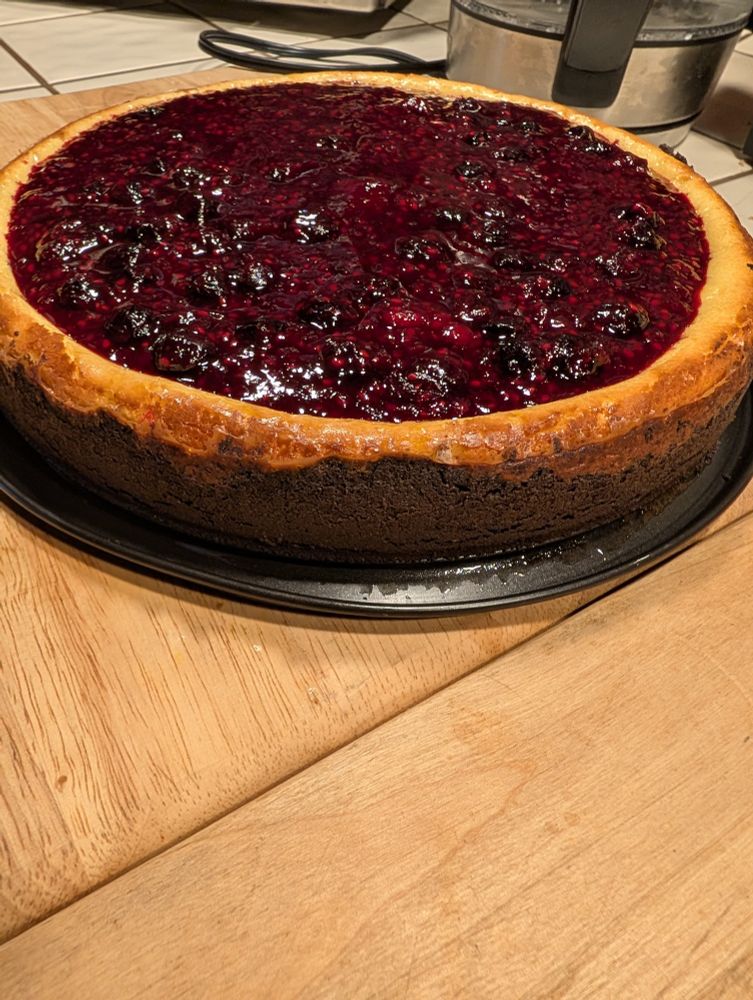 Berry topped cheesecake with gluten free Oreo crust.