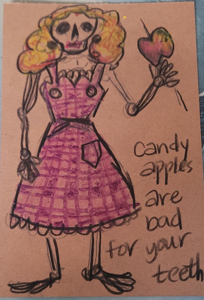 A postcard sized drawing of a skeleton wearing a pink and purple gingham apron and holding a candy apple on a stick. She has a poofy blonde wig and really tried on the lipstick to look nice but her lips are thin these days. The caption says CANDY APPLES ARE BAD FOR YOUR TEETH.