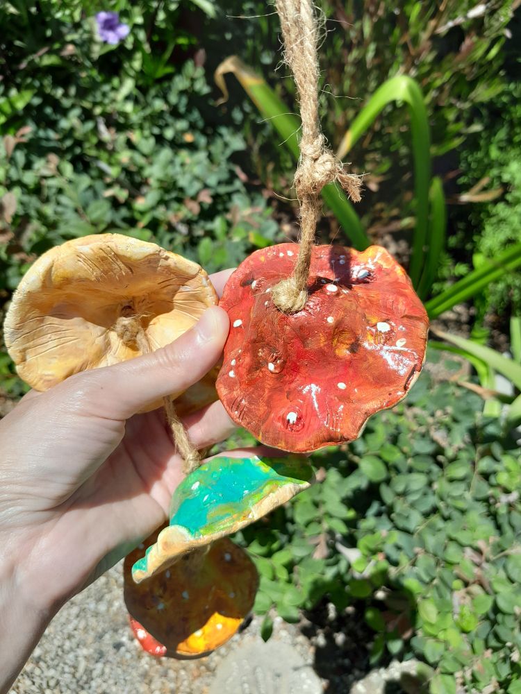 A close up of the top of one mushroom cap. It's painted red with white spots on the surface.