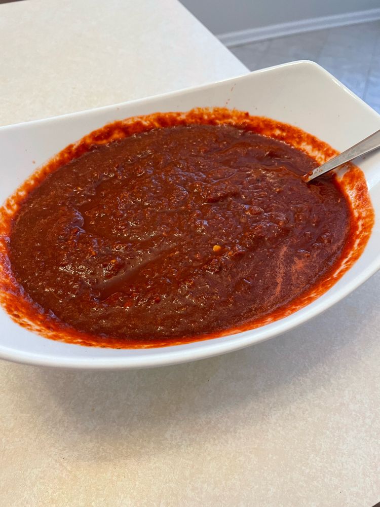 Finished salsa roja for chile colorado. Red salsa blended and transferred to a dish. 