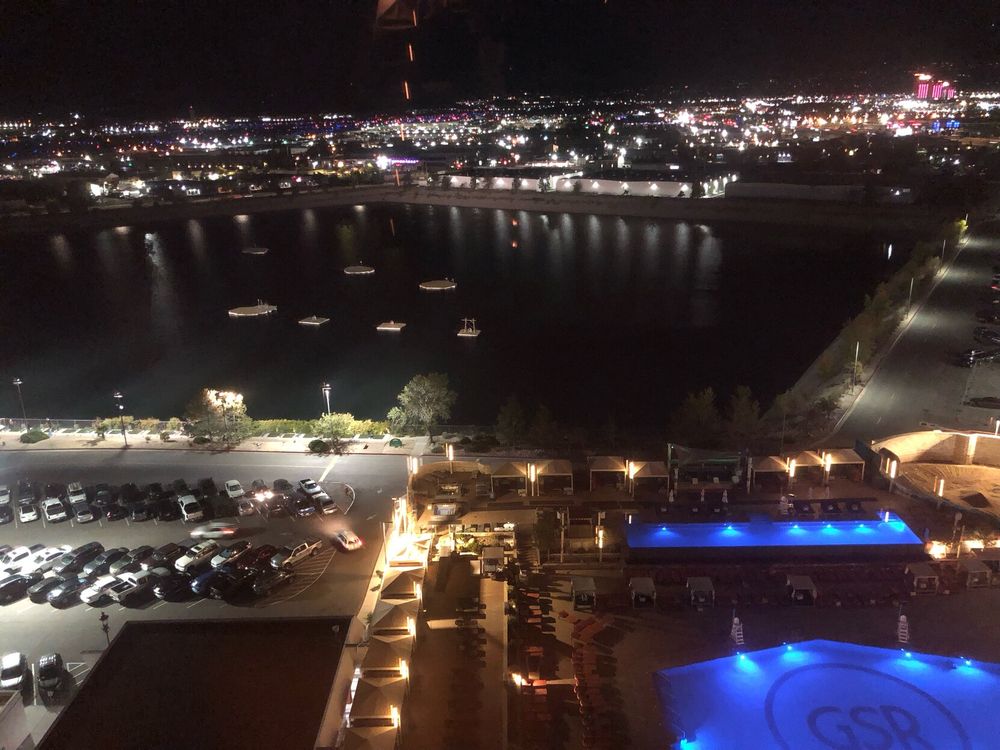 View from our hotel room overlooking Reno, Nevada at night. Lots of colorful lights illuminate the ground, viewed from several stories up. 