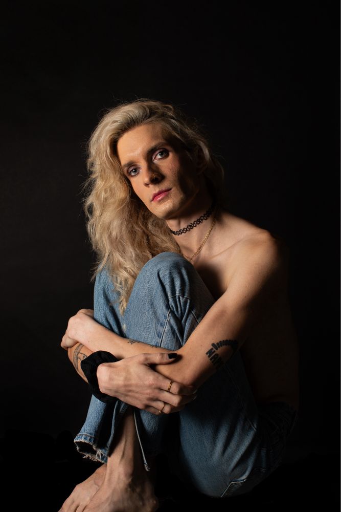 Jade topless hugging her knees in denim