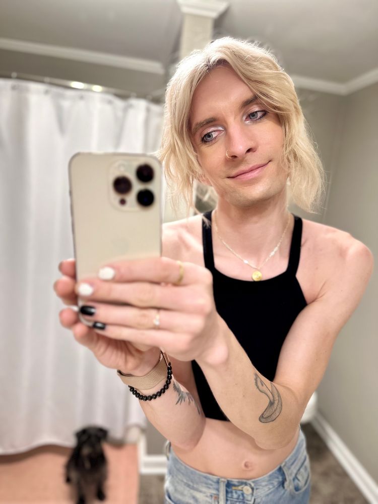 Jade feeling cute taking a bathroom selfie in a black razorback cropped top with her dog Camilla in the background waiting for Jade to get over herself 🐕‍🦺