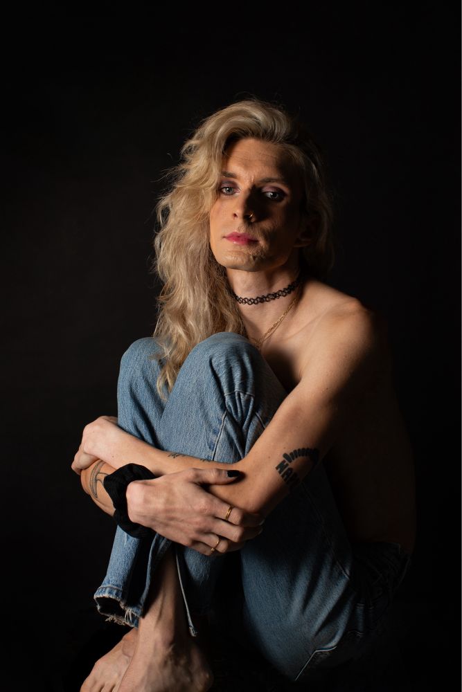Jade topless hugging her knees in denim