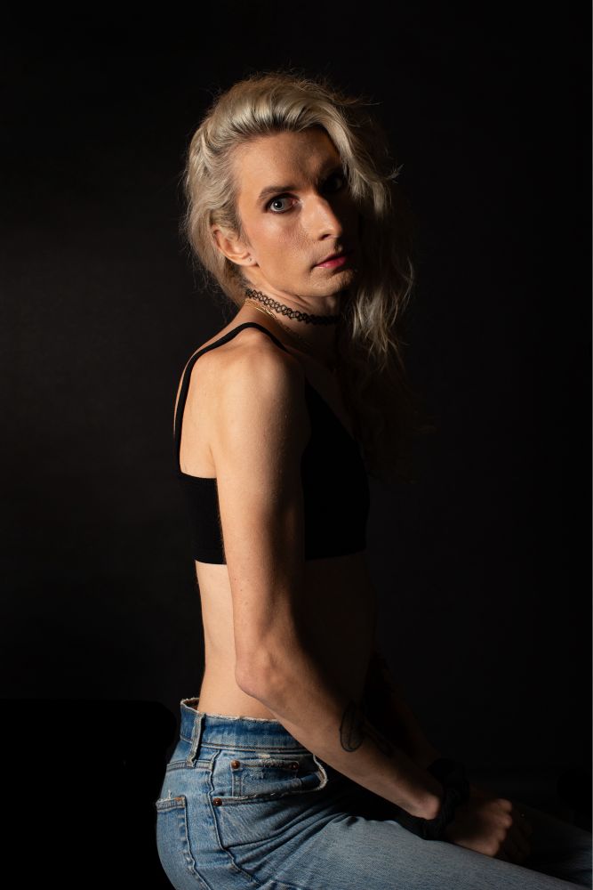 Jade in a black bralette and denim