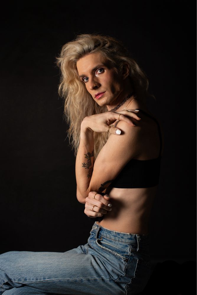 Jade in a black bralette and denim