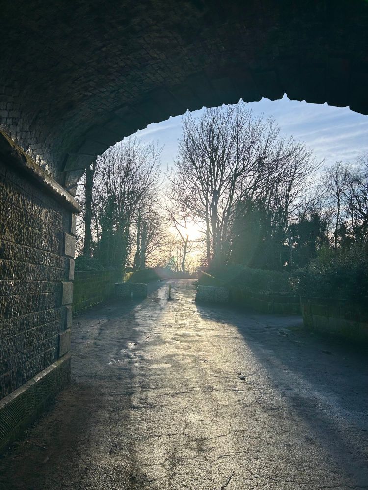 Looking through a railway bridge to a lighter sky 