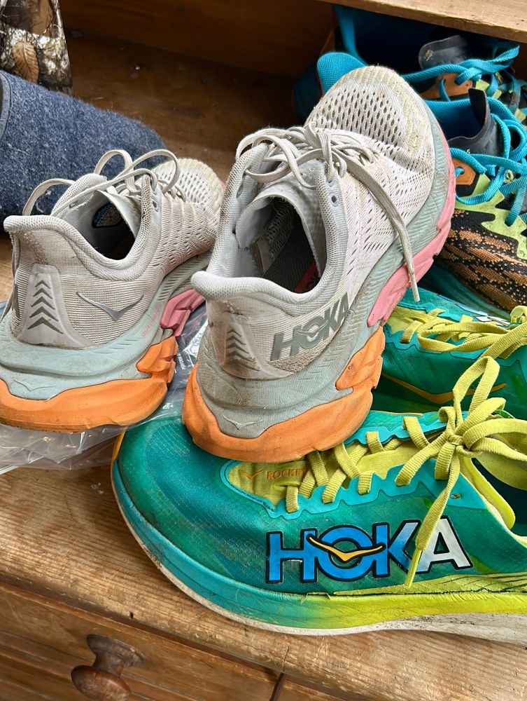 Two pairs of hoka running shoes 
