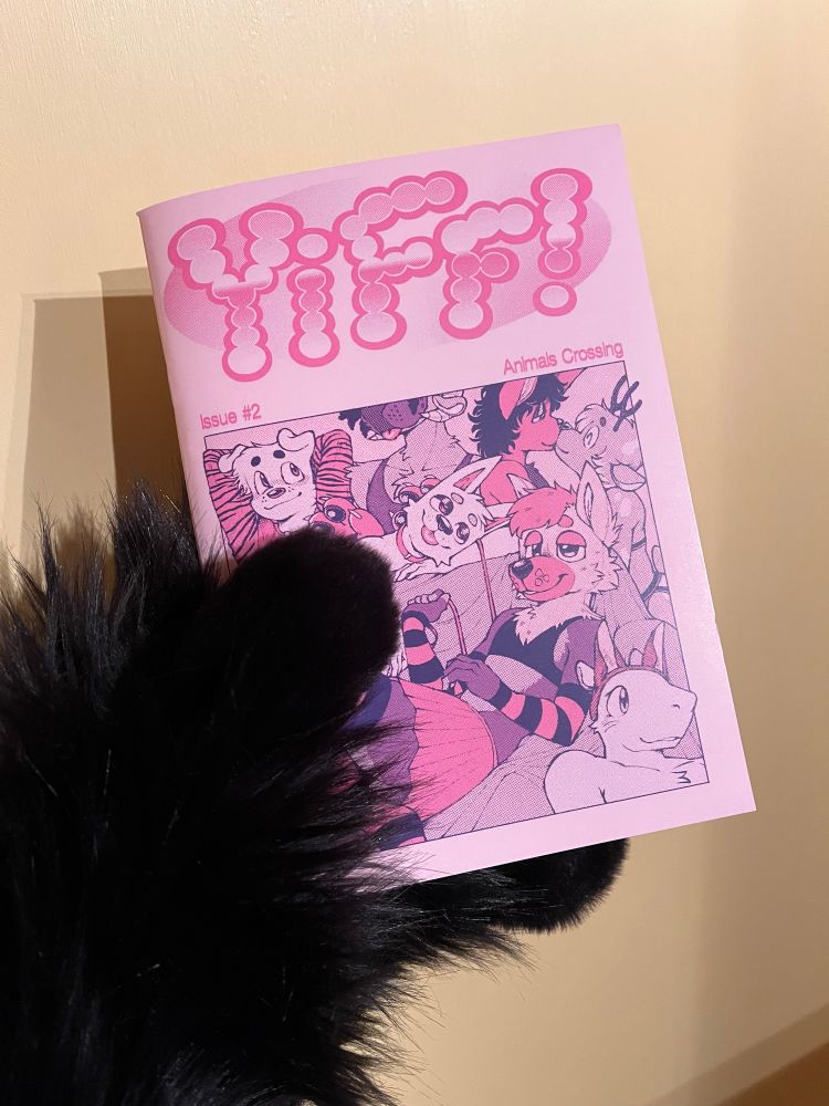 Yiff! issue 2 held by a black rabbit paw