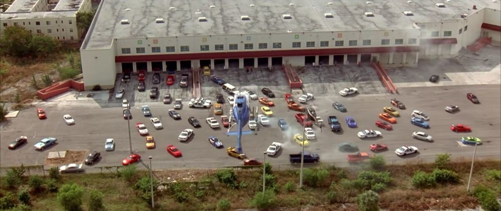Scene from the movie 2 Fast 2 Furious where street racers swarm out of a parking garage to overwhelm the Miami PD.