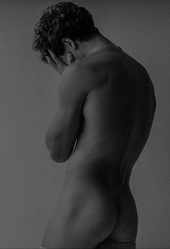 Male model resting his face in the palms of his hands 
