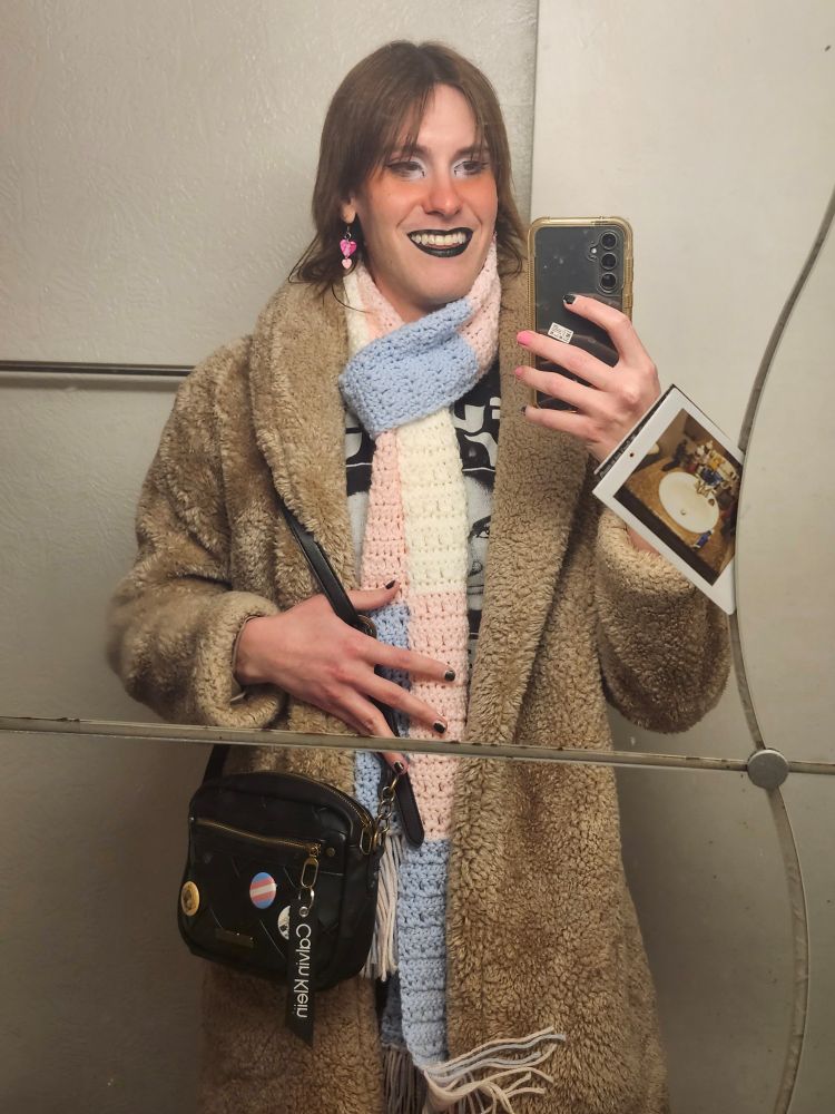 mirror selfie im in trans scarf, fake fur jacket, purse over shoulder and im smiling 