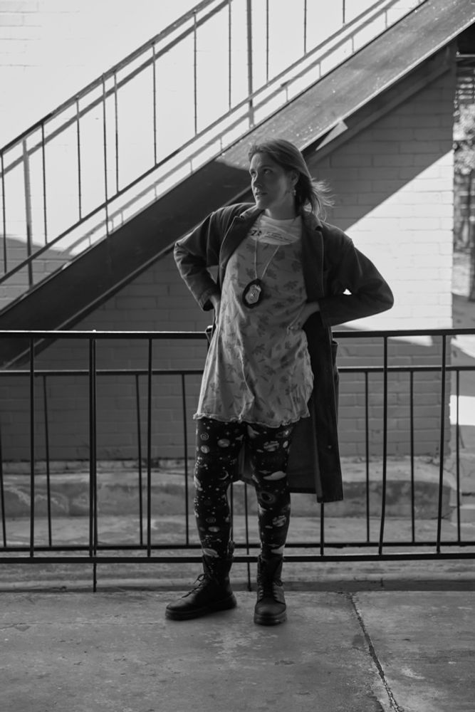 i need to copy / paste the outfit description it's another one of the black and white photos and it's gonna be the same outfit for all of them 

dorian electra concert long sleeve, pink flower dress, jean jacket trench, cupcake earrings, fake police badge, space tights, doc martins (not the shiney kind my friend had the shiney kind idk why he had to flex) 