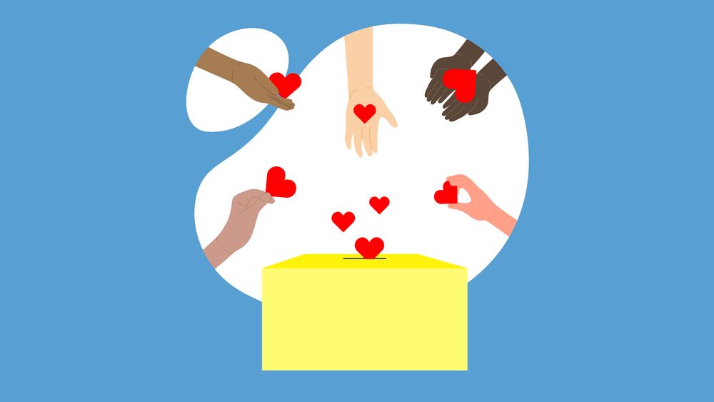 Plusieurs mains déposent des cœurs rouges dans une boîte à dons