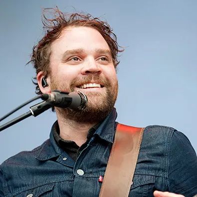 Frightened Rabbit frontman Scott Hutchison smiling with a microphone