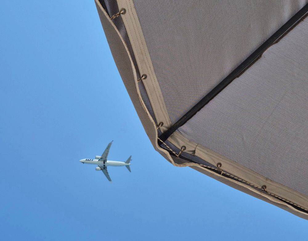 A plane flies overhead at 11:57am