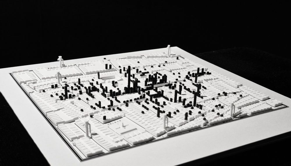 3D-printed map of Soho in 1854. Black marks on top of the buildings represent deaths from cholera caused by infected water from the Broad Street Pump (note the missing handle!). Side view.