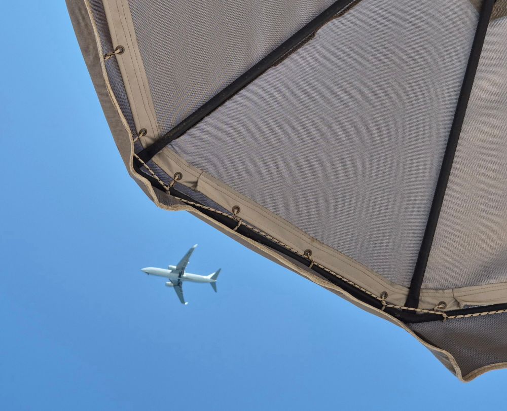 A plane flies overhead at 12:00pm