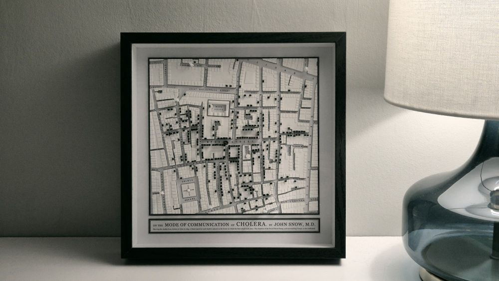 3D-printed map of Soho in 1854. Black marks on top of the buildings represent deaths from cholera caused by infected water from the Broad Street Pump (note the missing handle!). Frame, "artful" shot.