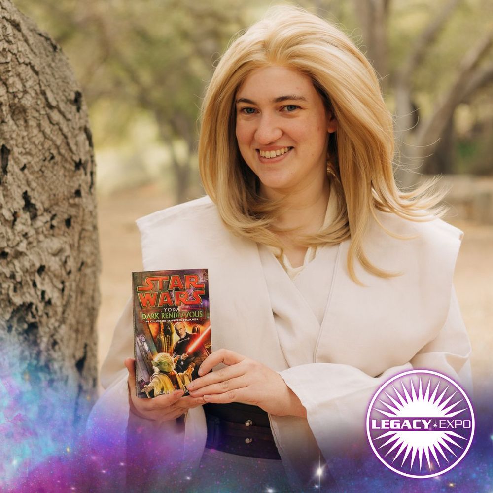 A photo of a Siri Tachi cosplayer holding a copy of "Yoda: Dark Rendezvous" by Sean Stewart