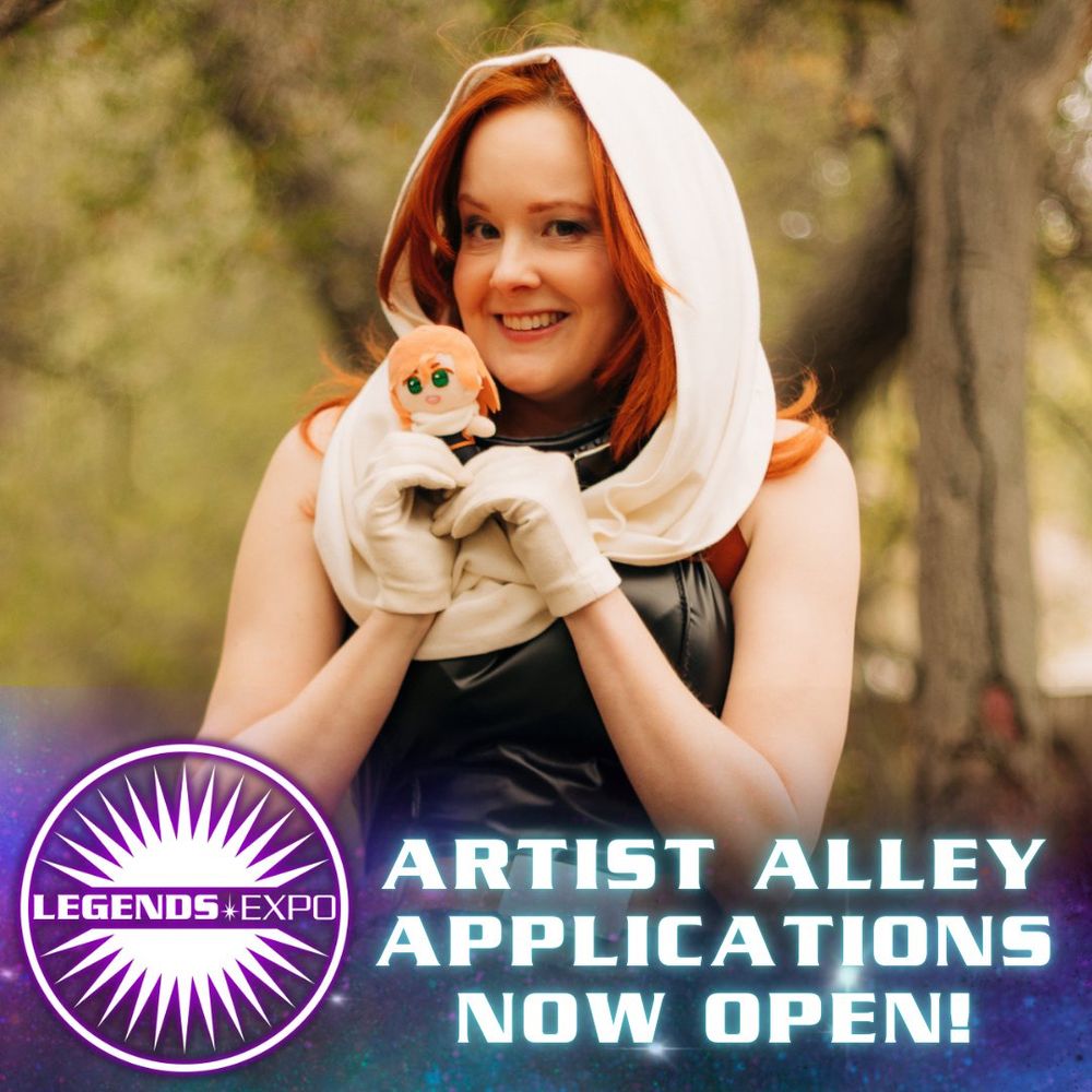 A photo of a Mara Jade costumer smiling and holding a hand-made Mara Jade doll close to her face
