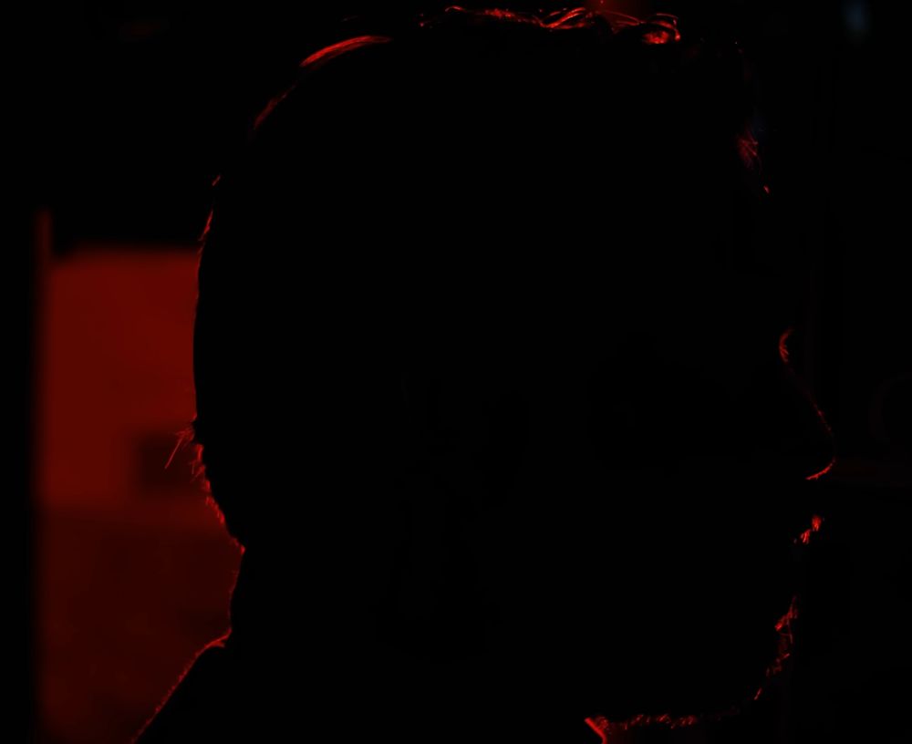 Jacob Geller's head in silhouette, red backlighting