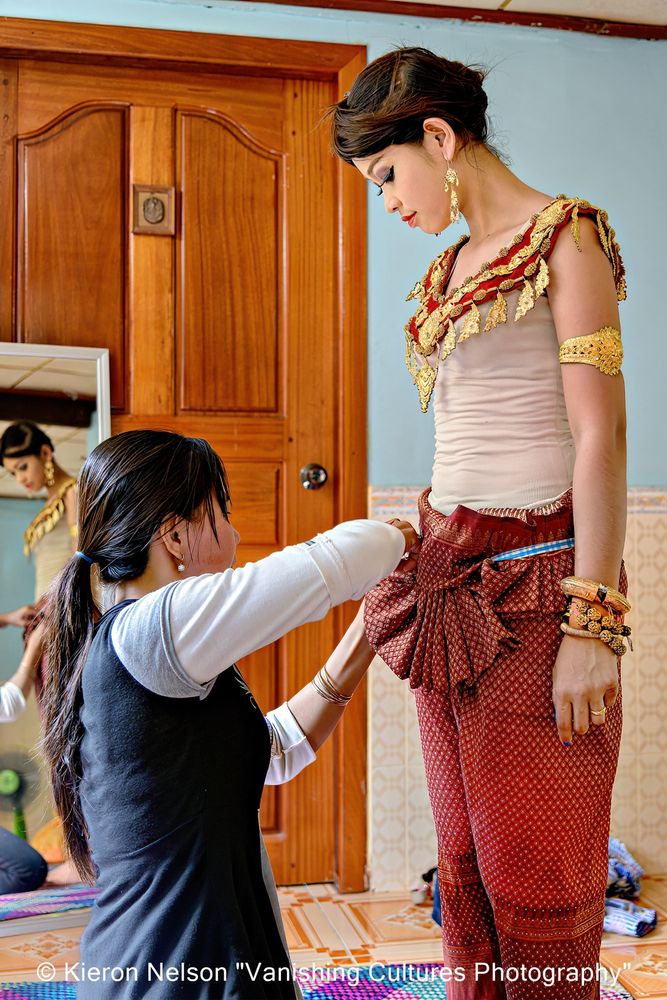 An Apsara (also spelled as Apsarasa) is a female spirit of the clouds and waters in Hindu and Buddhist mythology. Srey Leak waits patiently as her mother sews her into her costume. Her transformation to a "celestial maiden" in Cambodia is about to begin.