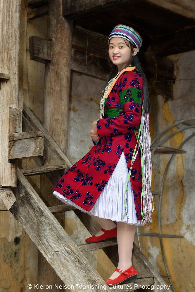 H'Mong girl Mouathi Ngoc in her festival dress. She is 17 years old. The H'Mong ethnic minority in Ha Giang Province, Vietnam, are known for their vibrant and distinctive festival attire, often featuring red and green colors with intricate embroidery and silver jewelry
