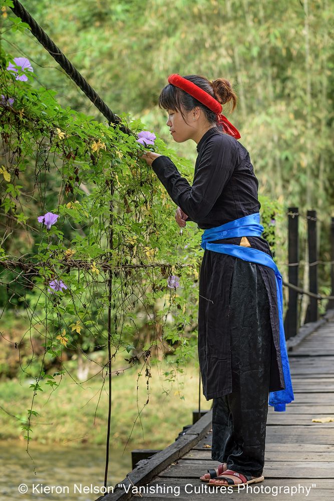 Northern Vietnam...Tay traditional dress is made from homegrown cotton that is indigo dyed. There is usually little to no embroidery or other decorations. Women wear skirts or trousers, often paired with short shirts underneath and long ones worn on top. Traditional Tay homes are often stilt houses, known as "nha san," built on wooden stilts with roofs made of grass, palm fronds, bamboo, or tiles. 